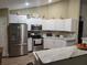 Modern kitchen with stainless steel appliances, bright countertops, and ample cabinet space at 254 Locust Pass Dr, Ocala, FL 34472