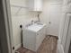 A well-equipped laundry room with a washer, dryer and storage space at 254 Locust Pass Dr, Ocala, FL 34472