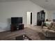 Open-concept living space features modern flooring, a large television, and a view into the dining area at 254 Locust Pass Dr, Ocala, FL 34472