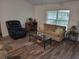 Cozy living room with a comfortable reclining chair, decorative fireplace, and sofa with colorful pillows at 254 Locust Pass Dr, Ocala, FL 34472