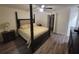 Spacious main bedroom with four-poster bed, ceiling fan, and wood-look floors at 254 Locust Pass Dr, Ocala, FL 34472