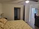 Comfortable main bedroom featuring a ceiling fan and wood-look flooring at 254 Locust Pass Dr, Ocala, FL 34472