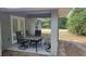 Covered patio with an outdoor dining table and chairs, perfect for relaxing and entertaining guests at 254 Locust Pass Dr, Ocala, FL 34472