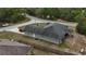 Aerial view of a home featuring a well-maintained exterior, large backyard, mature trees, and modern conveniences at 254 Locust Pass Dr, Ocala, FL 34472