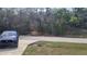 Street view with a blue car parked on the side of the road and mature trees at 254 Locust Pass Dr, Ocala, FL 34472