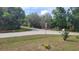Corner lot street view with manicured lawn and landscaping at 254 Locust Pass Dr, Ocala, FL 34472