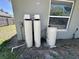 Exterior shot of the property's water system with two tanks next to a window at 254 Locust Pass Dr, Ocala, FL 34472