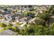 An aerial view of the neighborhood showcasing the home in relation to nearby houses and trees at 2564 Red Cedar Ln, The Villages, FL 32162