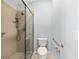 Modern bathroom featuring frameless glass shower, shower grab bars and comfort height toilet at 2564 Red Cedar Ln, The Villages, FL 32162