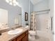 Well-lit bathroom with shower and tub combination and granite vanity at 2564 Red Cedar Ln, The Villages, FL 32162