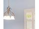 Dining area with chandelier featuring a window with white shutters at 2564 Red Cedar Ln, The Villages, FL 32162