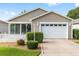 Charming single-story home featuring a well-manicured lawn and a white picket fence at 2564 Red Cedar Ln, The Villages, FL 32162