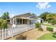 Charming home featuring a screen porch, well-maintained landscaping, and a white picket fence at 2564 Red Cedar Ln, The Villages, FL 32162
