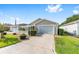 Beautiful single-story home featuring manicured lawn and landscaping plus a white picket fence at 2564 Red Cedar Ln, The Villages, FL 32162