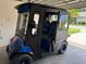 This custom golf cart has a comfortable interior, custom wheels, and full enclosure, and it is safely garaged at 2564 Red Cedar Ln, The Villages, FL 32162