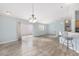 Bright living room featuring hardwood flooring, light blue walls, and sliding glass doors to the outside at 2564 Red Cedar Ln, The Villages, FL 32162