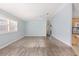 Bright living room featuring hardwood flooring, light blue walls, and a ceiling fan at 2564 Red Cedar Ln, The Villages, FL 32162