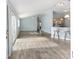 Open-concept living area with stylish flooring, vaulted ceilings and access to the kitchen at 2564 Red Cedar Ln, The Villages, FL 32162