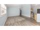 Bright living room featuring hardwood flooring, light blue walls, and a ceiling fan at 2564 Red Cedar Ln, The Villages, FL 32162