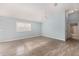 Bright main bedroom featuring hardwood flooring, light blue walls, and a ceiling fan at 2564 Red Cedar Ln, The Villages, FL 32162