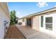 Spacious concrete patio featuring neutral siding, door to the interior, and view to the back yard at 2564 Red Cedar Ln, The Villages, FL 32162