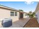 Side view of the patio, showing the home's exterior and the surrounding yard at 2564 Red Cedar Ln, The Villages, FL 32162