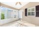 Bright sunroom featuring a decorative compass design on the floor at 2564 Red Cedar Ln, The Villages, FL 32162