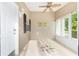 Bright sunroom with a decorative compass design on the floor and a tropical ceiling fan at 2564 Red Cedar Ln, The Villages, FL 32162