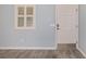 View of an interior wall featuring a window with white shutters and a white interior door at 2564 Red Cedar Ln, The Villages, FL 32162
