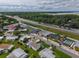 Community aerial view shows the pool, shuffleboard, and proximity to highway and trees at 2706 Vindale Rd, Tavares, FL 32778