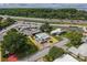 Property overview showcasing proximity to highway and trees, gravel landscaping, and nearby facilities in the aerial view at 2706 Vindale Rd, Tavares, FL 32778