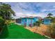 Lush backyard offering an artificial lawn and perimeter landscaping for a private and serene outdoor space at 2706 Vindale Rd, Tavares, FL 32778