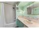 Bathroom featuring a shower-tub combination, a seashell-themed backsplash, a vanity, and ample lighting at 2706 Vindale Rd, Tavares, FL 32778