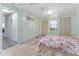 Bedroom featuring pale green walls, carpet flooring, two closets, and a ceiling fan at 2706 Vindale Rd, Tavares, FL 32778