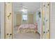Bedroom with floral bedding, bright walls, dual closets and a ceiling fan, radiating a cozy ambiance at 2706 Vindale Rd, Tavares, FL 32778