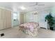 Bedroom featuring pale green walls, carpet flooring, two closets, and a ceiling fan at 2706 Vindale Rd, Tavares, FL 32778