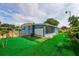 Charming mobile home featuring artificial turf, enclosed porch, blue siding, and well-maintained landscaping at 2706 Vindale Rd, Tavares, FL 32778