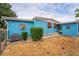 Well-maintained exterior with an air conditioning unit, colorful accents, and a cozy backyard area at 2706 Vindale Rd, Tavares, FL 32778
