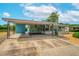 Charming home showcasing a lovely exterior, covered parking, and well-maintained landscaping at 2706 Vindale Rd, Tavares, FL 32778