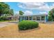 Beautifully landscaped front exterior with lush greenery, a spacious driveway, and inviting curb appeal at 2706 Vindale Rd, Tavares, FL 32778