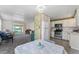 Open-concept kitchen and living space featuring modern appliances, white cabinetry, and access to a sunroom at 2706 Vindale Rd, Tavares, FL 32778