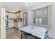 Bright kitchen and dining area featuring white cabinetry, modern appliances, and a view to the yard through large windows at 2706 Vindale Rd, Tavares, FL 32778