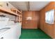 Functional laundry area with washer, dryer, and shelving for storage and organization in the home at 2706 Vindale Rd, Tavares, FL 32778