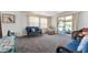 Inviting living room featuring comfortable seating, plush carpets, and large windows offering abundant natural light at 2706 Vindale Rd, Tavares, FL 32778