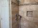 Stylish bathroom with travertine tile and modern fixtures in the shower at 3083 Pinnacle Ct, Clermont, FL 34711