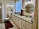 Bathroom featuring double sinks, granite countertops, and decorative lighting at 3083 Pinnacle Ct, Clermont, FL 34711