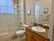 Bright bathroom features a granite-topped vanity, wide mirror, and tiled shower/tub enclosure at 3083 Pinnacle Ct, Clermont, FL 34711