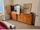 Bedroom showcasing dressers, a TV hutch, and a painting on the wall at 3083 Pinnacle Ct, Clermont, FL 34711