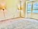 Cozy bedroom featuring carpet flooring, natural light, and sconce lighting at 3083 Pinnacle Ct, Clermont, FL 34711