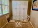 Breakfast nook features a glass topped table, seating for three, and a view from the nearby window at 3083 Pinnacle Ct, Clermont, FL 34711